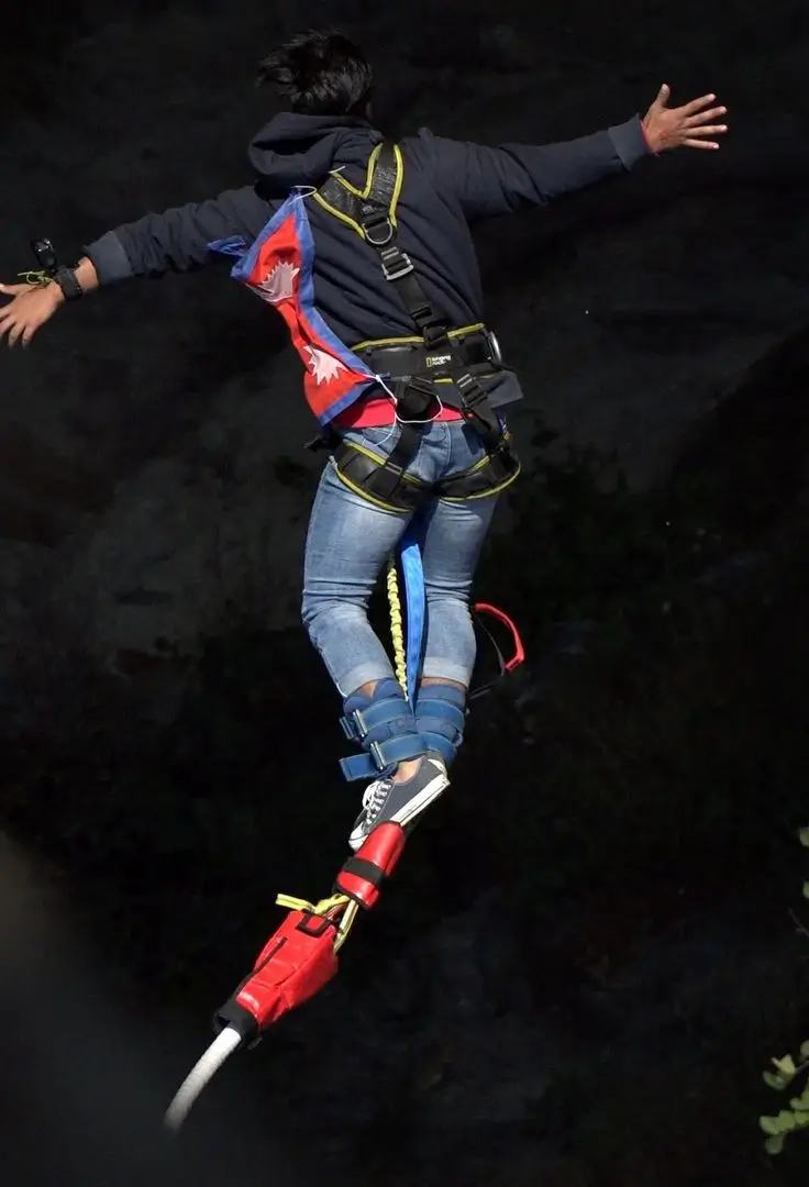 Jumper in free fall from the bungee platform in Rishikesh