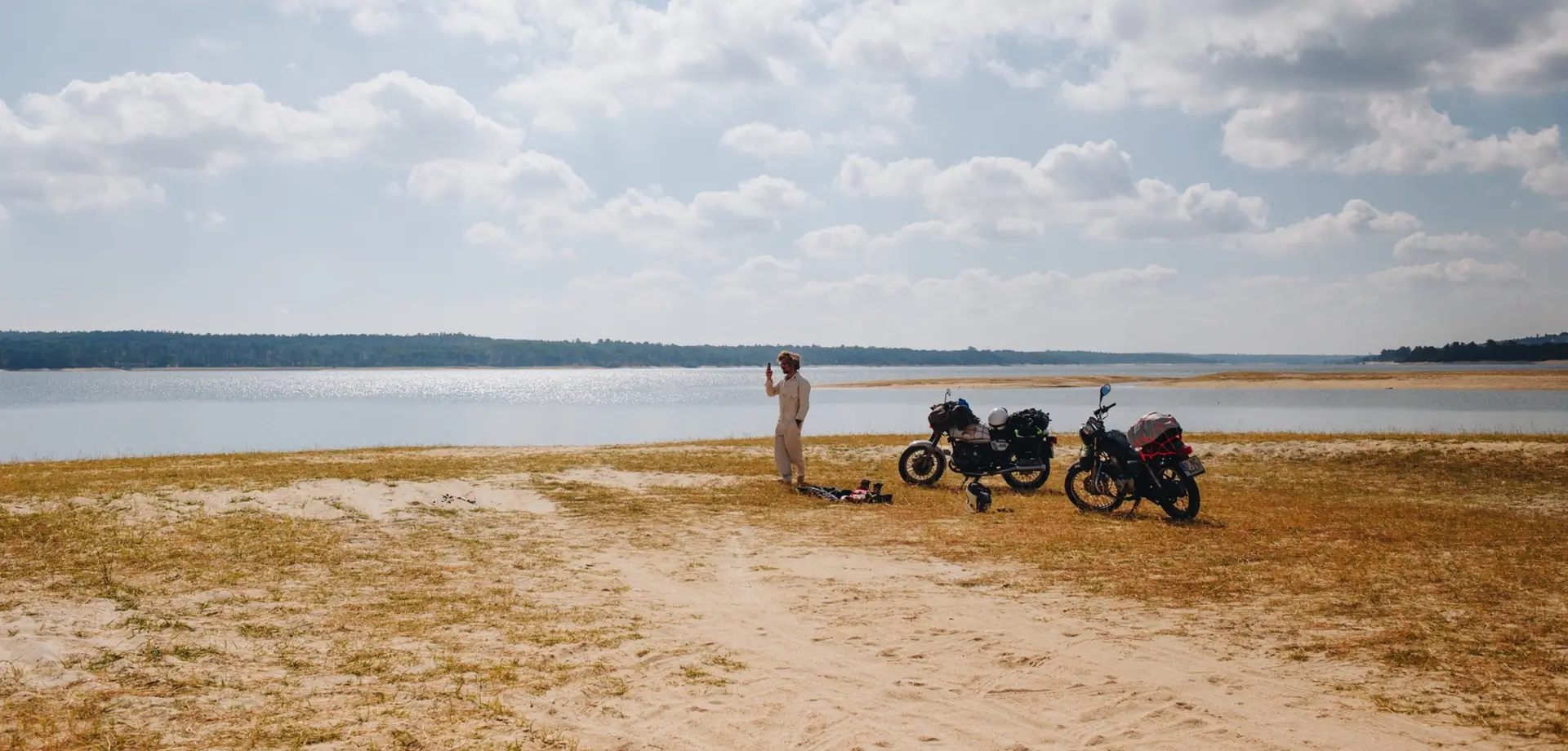Motorcycles parked by a lake on a Rishikesh road trip